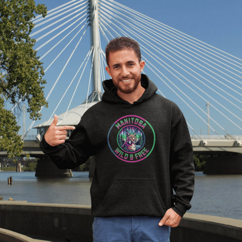 Step into the wild with our Manitoba – Wild & Free hoodie, featuring a striking graphic of a lynx under the glow of the northern lights.