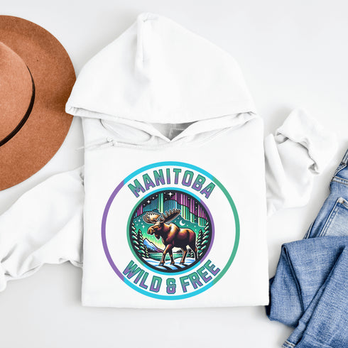 Step into the wild with our Manitoba – Wild & Free hoodie, featuring a majestic moose silhouetted against the breathtaking northern lights.