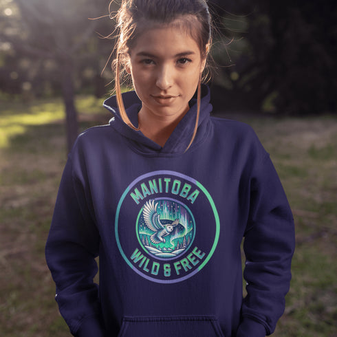 Embrace the magic of the prairies with our Manitoba – Wild & Free hoodie, featuring a captivating graphic of a snowy owl in flight beneath the shimmering northern lights.