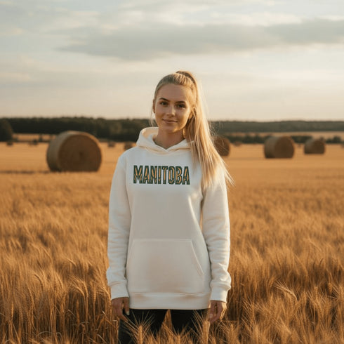 Stay cozy and stylish with this Manitoba-themed hoodie featuring the letters filled with wheat. Perfect for anyone looking for a cozy hoodie to wear during winter.