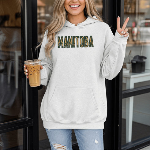 Stay cozy and stylish with this Manitoba-themed hoodie featuring the letters filled with wheat. Perfect for anyone looking for a cozy hoodie to wear during winter.