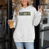 Stay cozy and stylish with this Manitoba-themed hoodie featuring the letters filled with wheat. Perfect for anyone looking for a cozy hoodie to wear during winter.