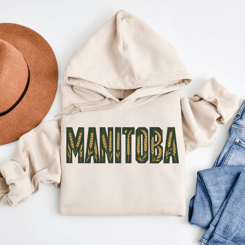 Stay cozy and stylish with this Manitoba-themed hoodie featuring the letters filled with wheat. Perfect for anyone looking for a cozy hoodie to wear during winter.