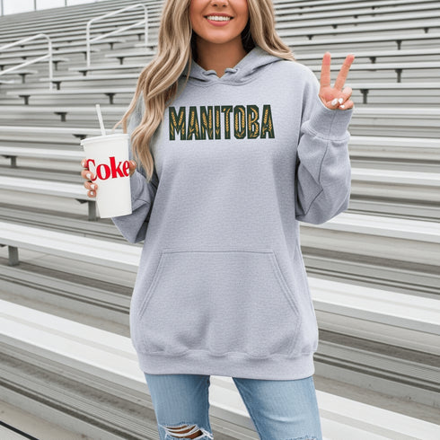 Stay cozy and stylish with this Manitoba-themed hoodie featuring the letters filled with wheat. Perfect for anyone looking for a cozy hoodie to wear during winter.