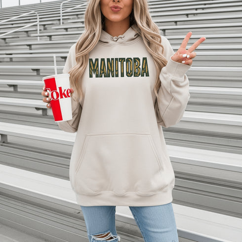 Stay cozy and stylish with this Manitoba-themed hoodie featuring the letters filled with wheat. Perfect for anyone looking for a cozy hoodie to wear during winter.