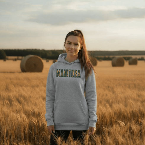 Stay cozy and stylish with this Manitoba-themed hoodie featuring the letters filled with wheat. Perfect for anyone looking for a cozy hoodie to wear during winter.