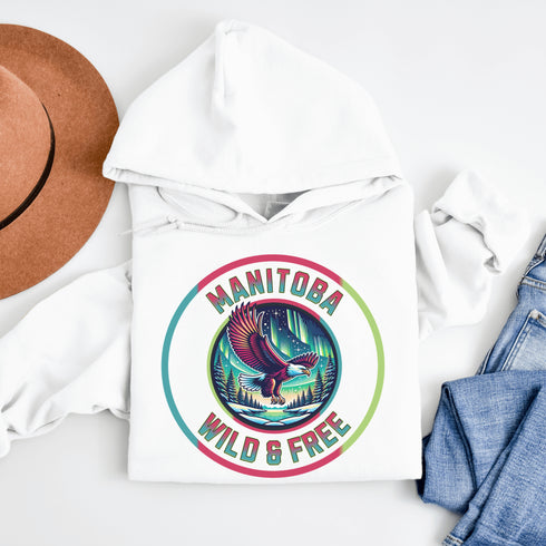 Soar high in our Manitoba – Wild & Free hoodie, featuring a bold flying bald eagle beneath the captivating northern lights.