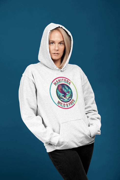 Soar high in our Manitoba – Wild & Free hoodie, featuring a bold flying bald eagle beneath the captivating northern lights.
