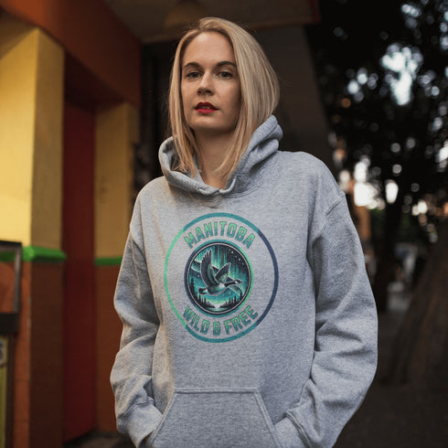 Embrace the spirit of the prairies with our Manitoba – Wild & Free hoodie, featuring a stunning graphic of a Canadian goose in flight beneath the mesmerizing northern lights.