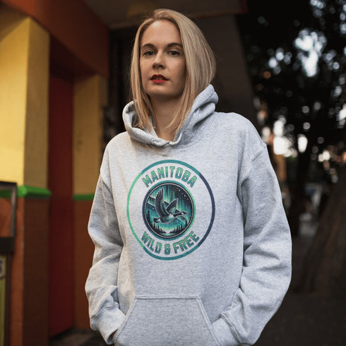 Embrace the spirit of the prairies with our Manitoba – Wild & Free hoodie, featuring a stunning graphic of a Canadian goose in flight beneath the mesmerizing northern lights.