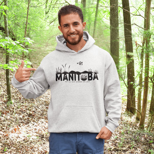 Featuring a prairie landscape, the design showcases wildflowers and prairie grasses blooming from the letters "Manitoba," artfully integrated into the scene.