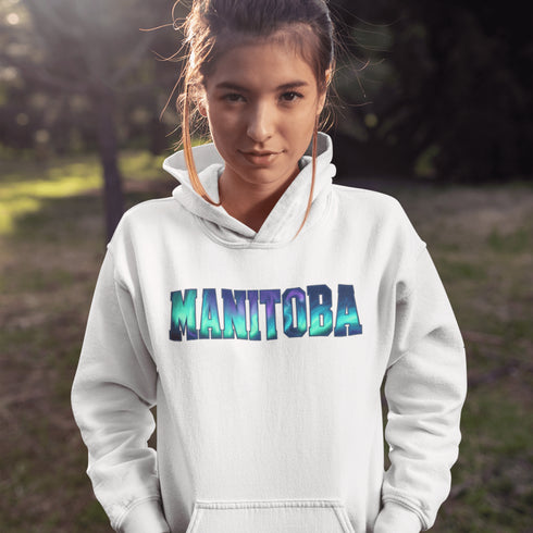 Our Manitoba Northern Lights Hoodie features the province’s name in a stunning aurora-inspired font that shimmers with the spirit of the North.