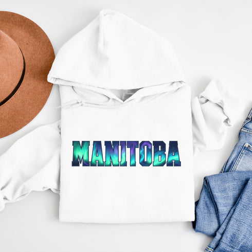 Our Manitoba Northern Lights Hoodie features the province’s name in a stunning aurora-inspired font that shimmers with the spirit of the North.