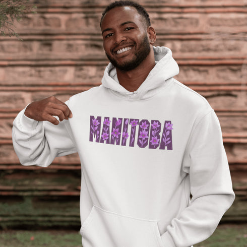 Celebrate the beauty of the prairies with our Manitoba Hoodie, featuring bold lettering filled with delicate purple prairie crocus flowers.