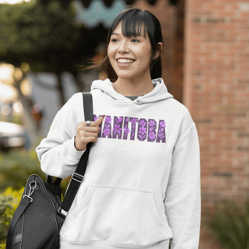 Celebrate the beauty of the prairies with our Manitoba Hoodie, featuring bold lettering filled with delicate purple prairie crocus flowers.
