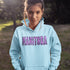 Celebrate the beauty of the prairies with our Manitoba Hoodie, featuring bold lettering filled with delicate purple prairie crocus flowers.