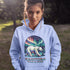 Featuring a majestic polar bear set against the breathtaking backdrop of the northern lights, this hoodie celebrates the spirit of Manitoba’s wild landscapes.