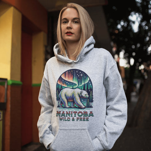 Featuring a majestic polar bear set against the breathtaking backdrop of the northern lights, this hoodie celebrates the spirit of Manitoba’s wild landscapes.