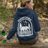 This cozy hoodie features a bold back print of a bear walking beneath a crescent moon and pine trees—capturing everything we love about Canada’s wilderness.