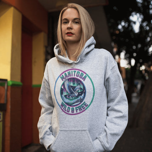 Featuring a stunning graphic of a majestic snowy owl in flight, set against the glowing northern lights, this hoodie embodies the freedom and grace of the province’s untamed wilderness.