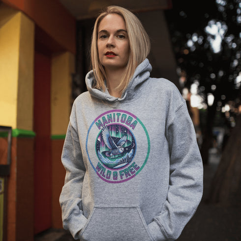 Featuring a stunning graphic of a majestic snowy owl in flight, set against the glowing northern lights, this hoodie embodies the freedom and grace of the province’s untamed wilderness.