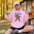 Funny Sasquatch fishing graphic printed on a unisex hoodie featuring a vintage Bigfoot fisherman design, shown on multiple hoodie colors and lifestyle mockups perfect for outdoor and fishing apparel.