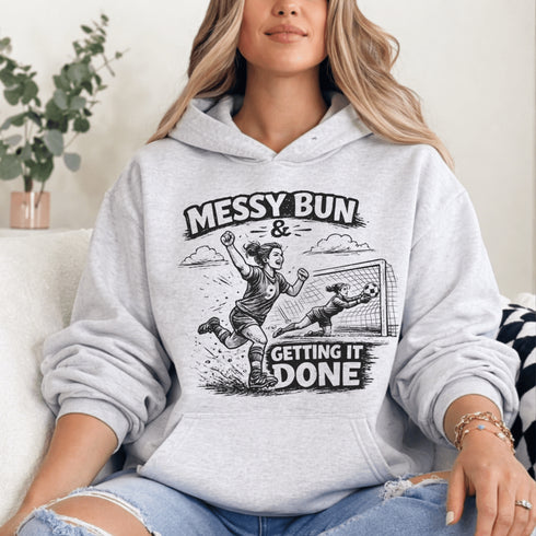 Woman wearing a Messy Bun & Getting It Done soccer mom hoodie with vintage soccer design