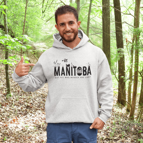 Featuring a serene prairie landscape, the design captures the essence of the heartland with wildflowers and prairie grasses growing out of the letters Manitoba.