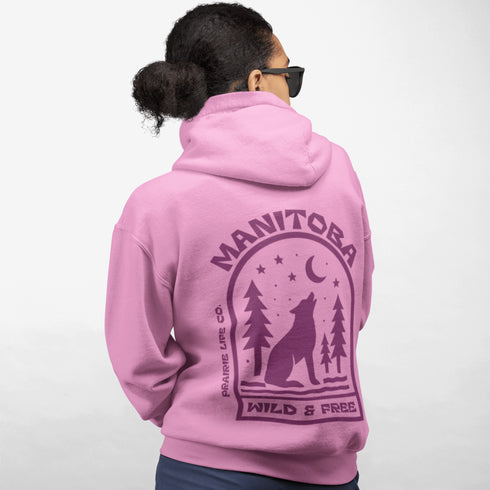 Featuring a howling wolf surrounded by pine trees, twinkling stars, and a crescent moon, this hoodie captures the magic of the northern wilderness.