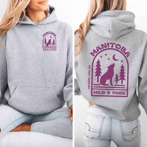 Featuring a howling wolf surrounded by pine trees, twinkling stars, and a crescent moon, this hoodie captures the magic of the northern wilderness.