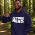 Man wearing a blue hoodie with 'Nature Nerd' text in a forest setting