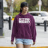 Person wearing a purple hoodie with 'Nature Nerd' text on a street.