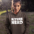 Person wearing a hoodie with 'Nature Nerd' text outdoors