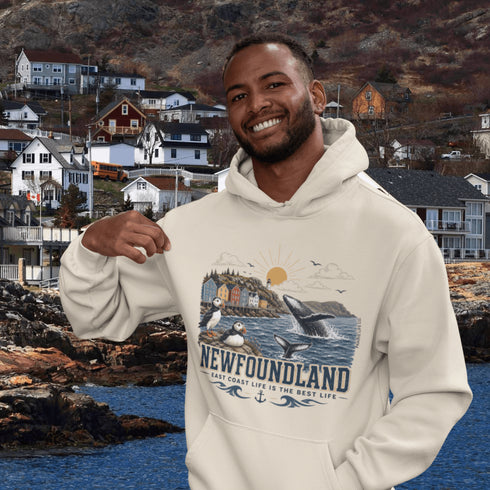 Man wearing a hoodie with a Newfoundland design in front of a scenic background