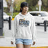 Woman wearing a hoodie with a 'Newfoundland' design on a street.