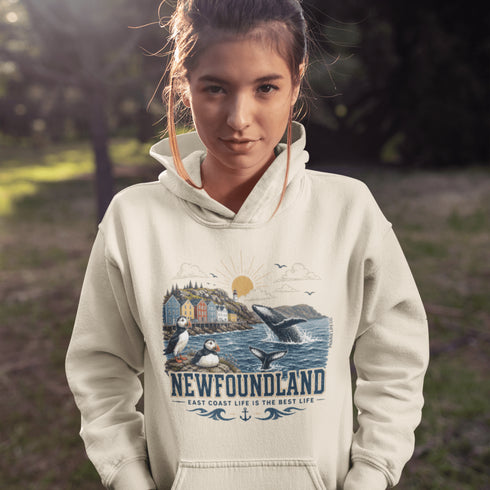 Newfoundland graphic hoodie featuring puffins, whale, fishing village, and coastal East Coast Canada design on a unisex sweatshirt