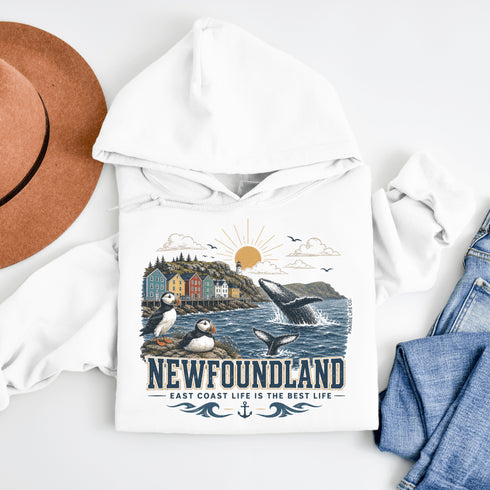 Newfoundland graphic hoodie featuring puffins, whale, fishing village, and coastal East Coast Canada design on a unisex sweatshirt