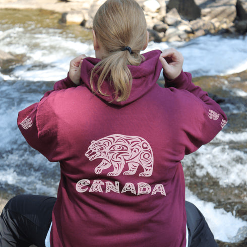 Northern Heritage Bear Hoodie featuring Indigenous-inspired bear artwork and bear paw sleeve graphics. Cozy Canada pullover sweatshirt built for warmth, heritage, and style.
