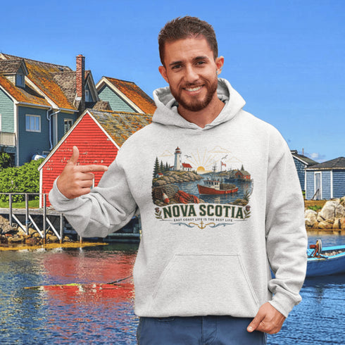 Nova Scotia hoodie with lighthouse coastal fishing village graphic worn by model outdoors near ocean cliffs
