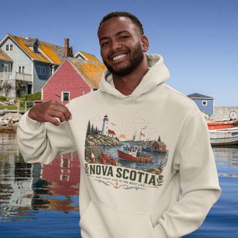 Nova Scotia hoodie with lighthouse coastal fishing village graphic worn by model outdoors near ocean cliffs