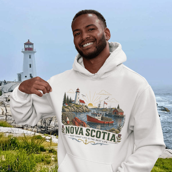 Nova Scotia hoodie with lighthouse coastal fishing village graphic worn by model outdoors near ocean cliffs