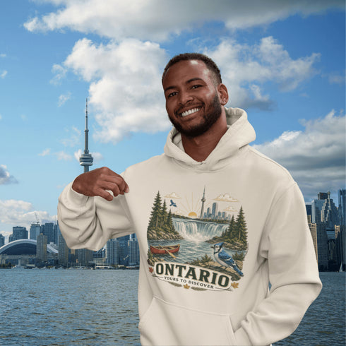 Man wearing a hoodie with a scenic design of Ontario, standing in front of a city skyline with water and clouds.