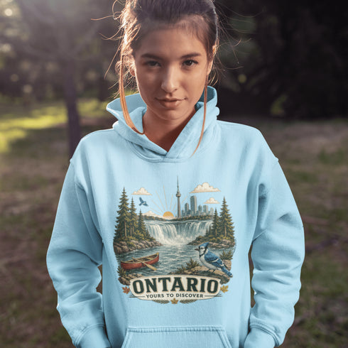 Person wearing a light blue hoodie with Ontario-themed design outdoors