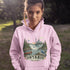 Person wearing a pink hoodie with Ontario-themed design outdoors
