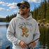 Unisex Gildan 18500 hoodie featuring a vintage-style Bigfoot fishing graphic with the phrase "Out Here Living My Best Life," available in multiple colors.