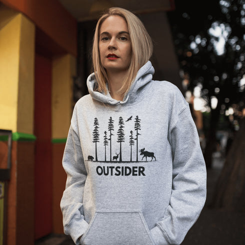 The Outsider Hoodie features a charming forest scene with a moose, a bear, and a deer—aka the unspoken rulers of the woods.