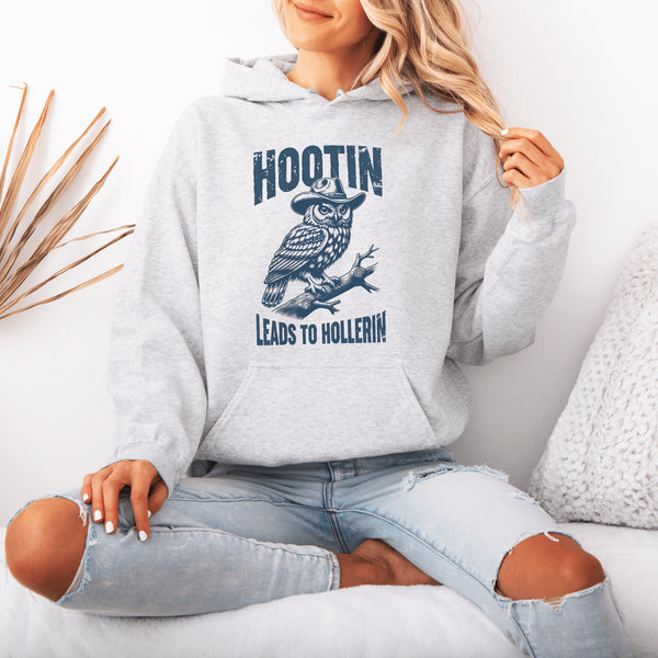 Rocking a cowboy hat and perched on a tree branch, this feathered outlaw knows the golden rule of life: Hootin’ leads to hollerin’.