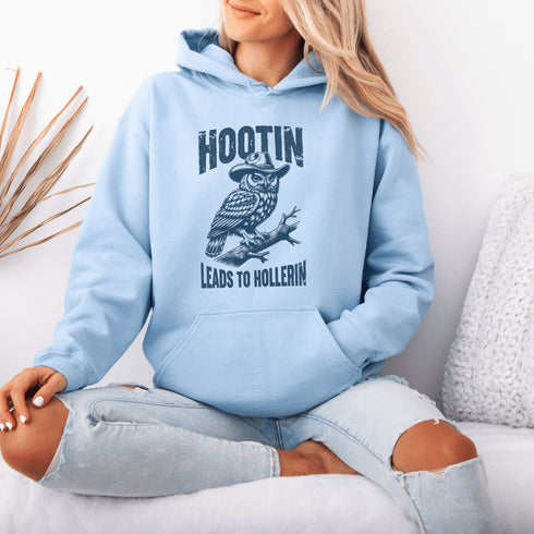 Rocking a cowboy hat and perched on a tree branch, this feathered outlaw knows the golden rule of life: Hootin’ leads to hollerin’.