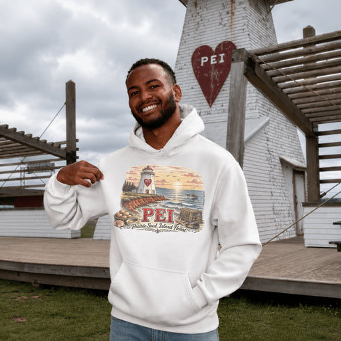 Man wearing a white hoodie with PEI design in front of a lighthouse structure.