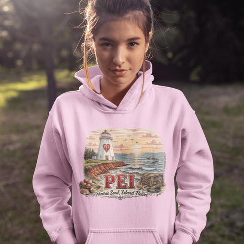 Person wearing a pink hoodie with a lighthouse design and 'PEI' text outdoors.